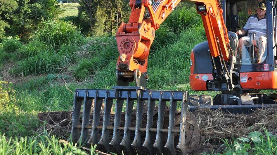 How does the mini excavator landscape rake help in environmental protection